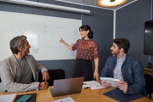 Large enterprise employees discussing how to accelerate the checkout experience for customers. 