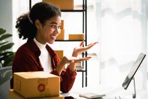 Small business owner setting up shipping for boxes online