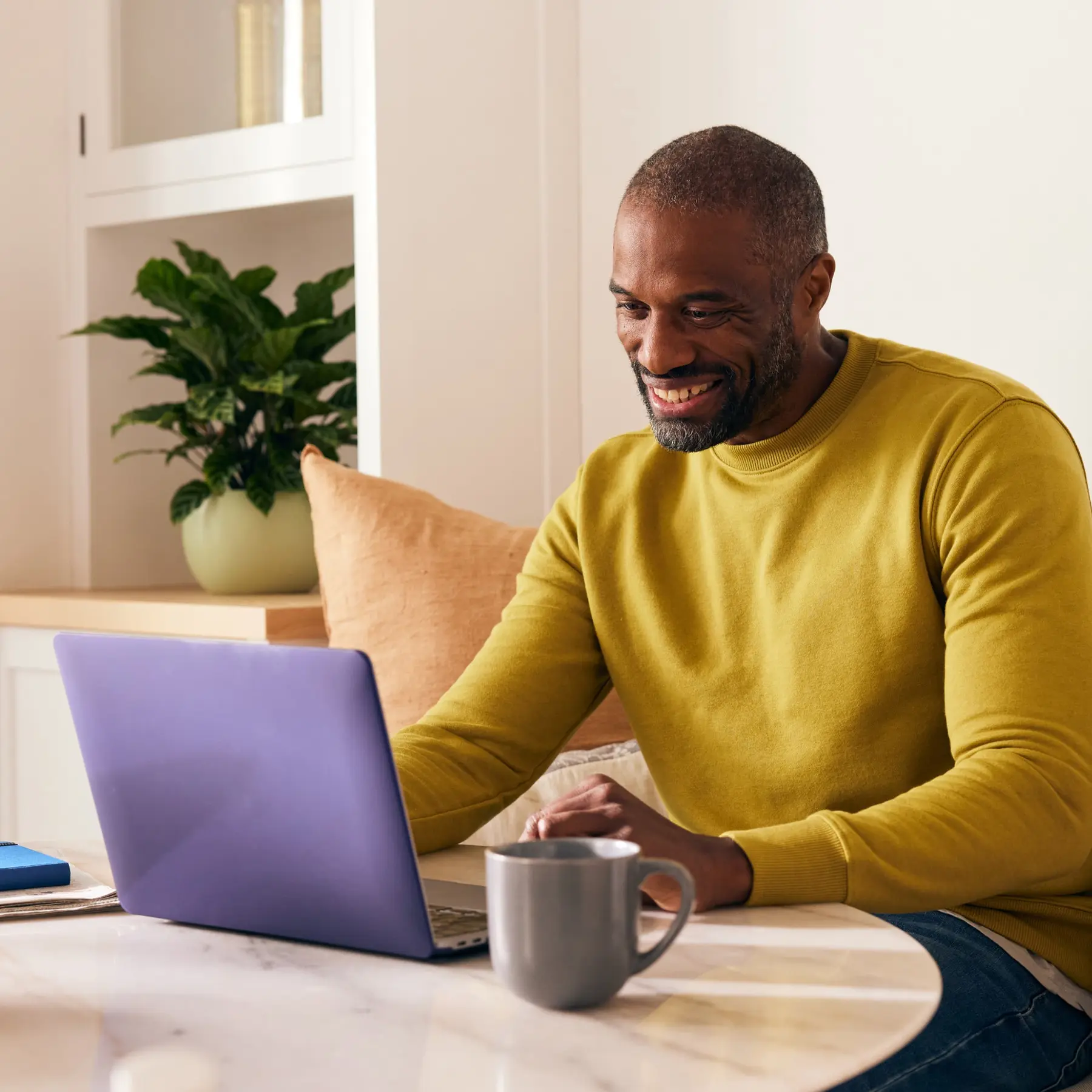 Man sitting at a desk in front of a laptop